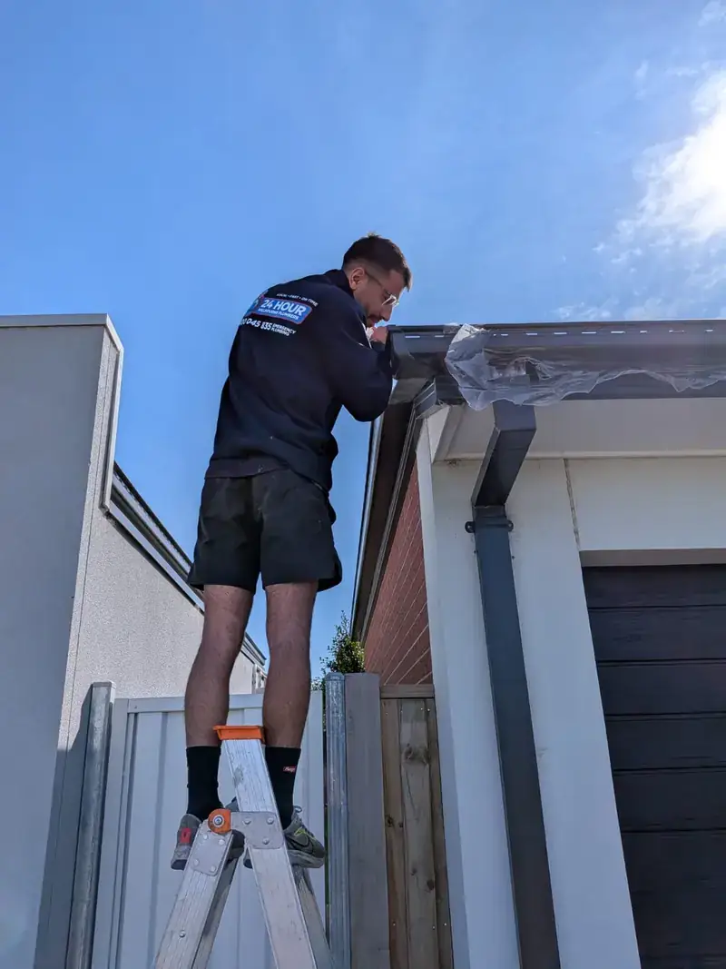 Roof plumber working on gutter in Bentleigh